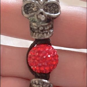 Black skul and red bracelet